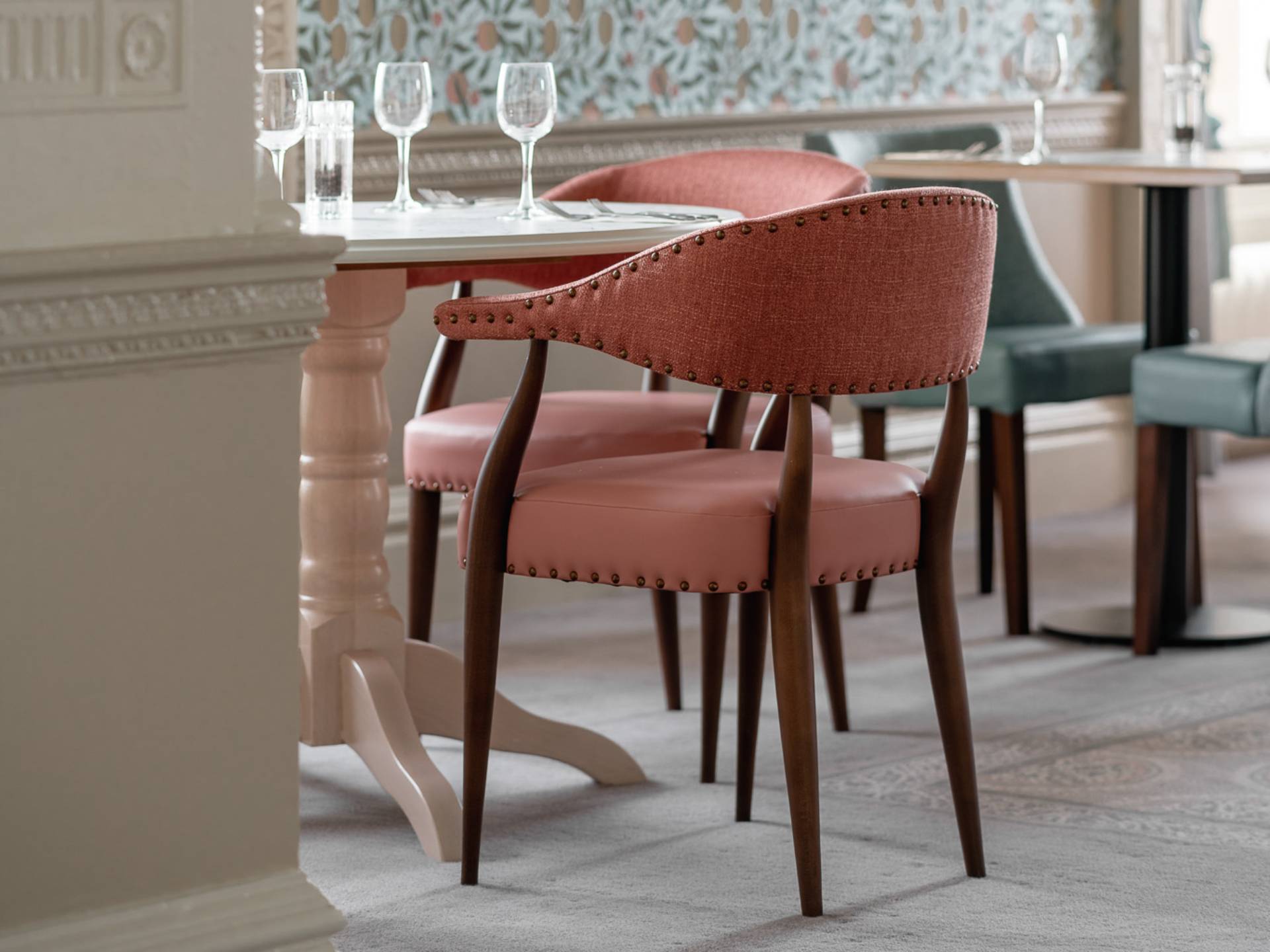 Coral pink chair in restaurant at HeyThrop Park Hotel