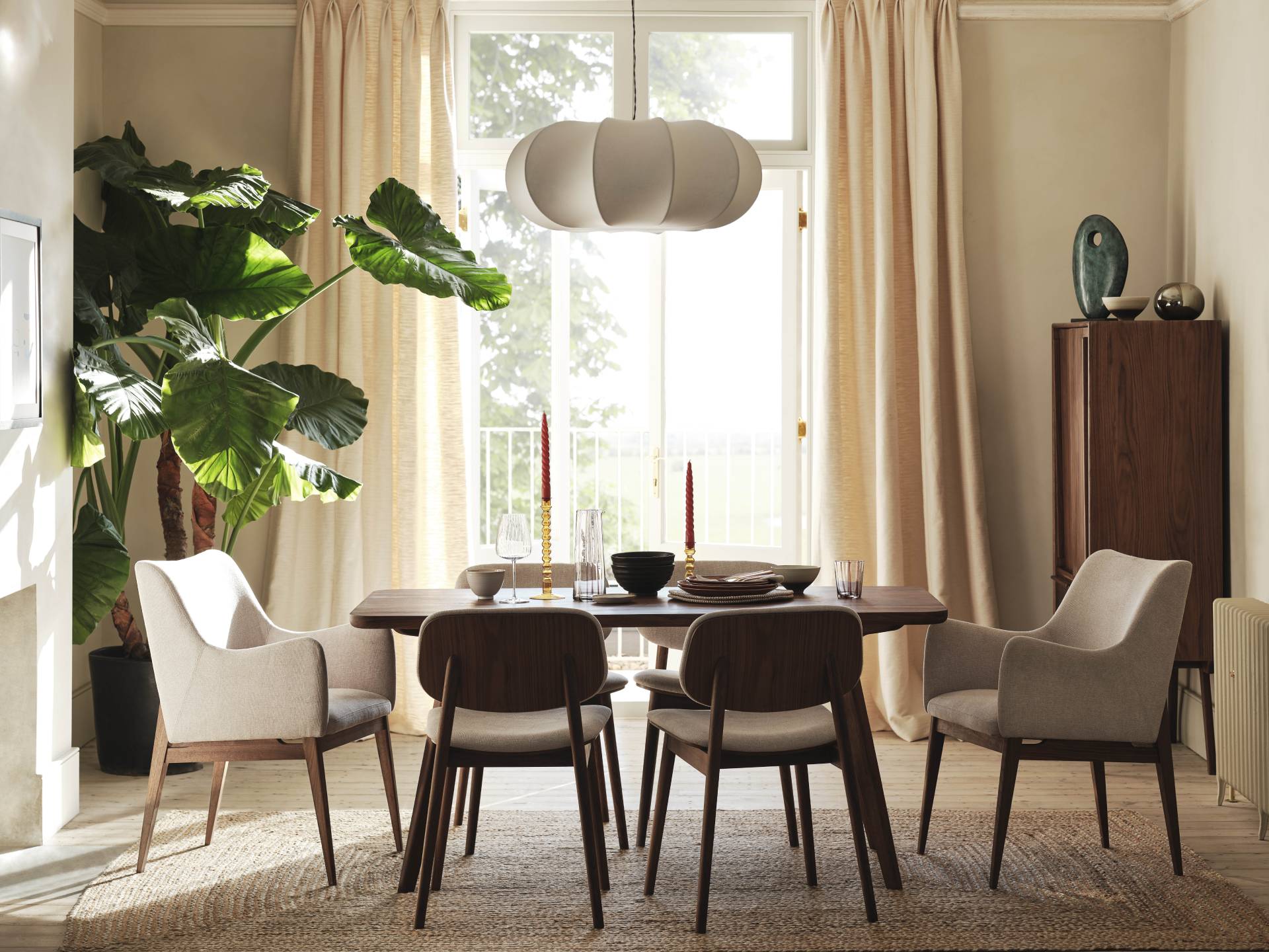 Dining room with oval table and mix of carver and armless chairs