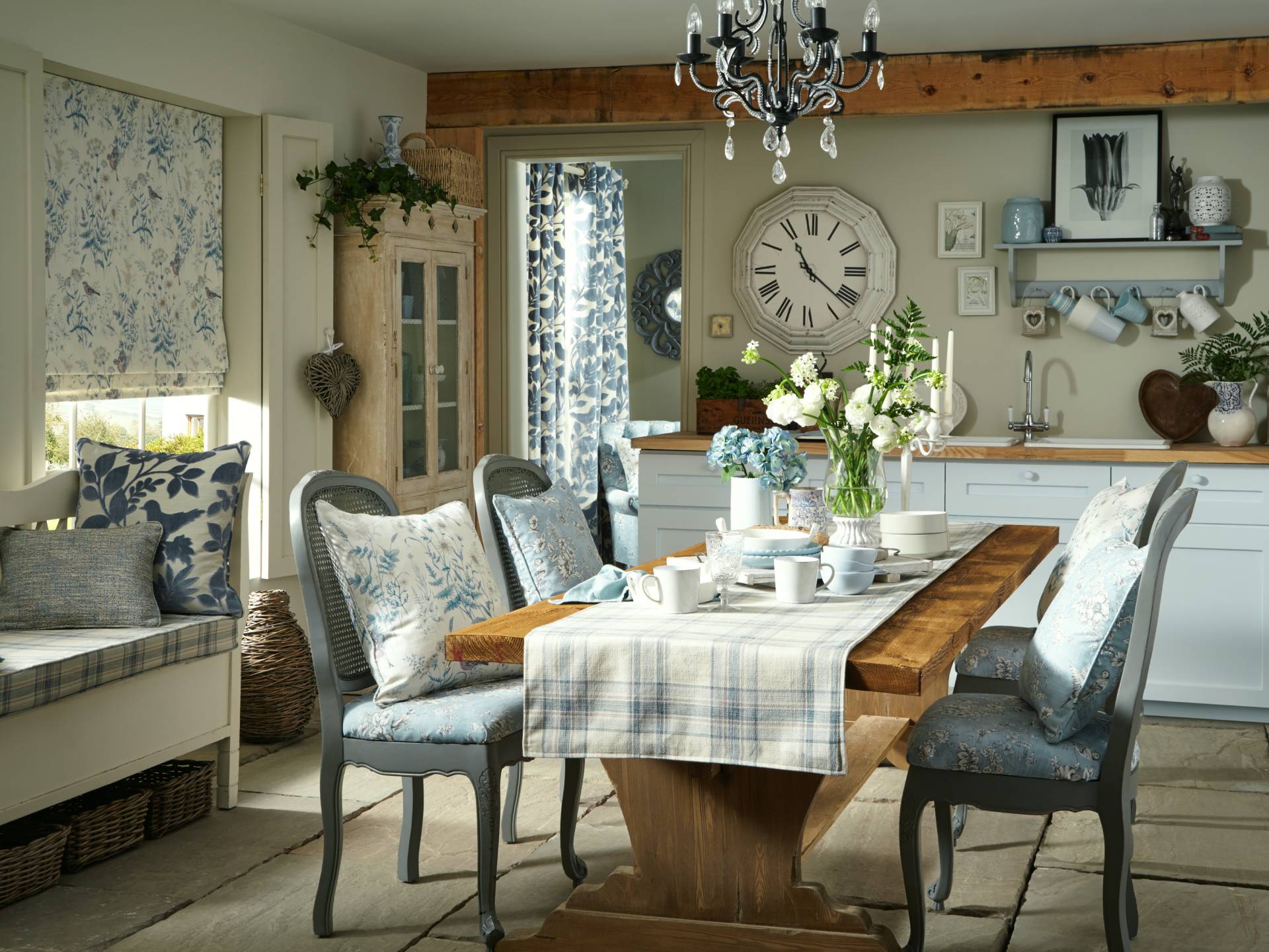 pillowed-blue/grey dining chairs with wood table and blue squared quilt/cover
