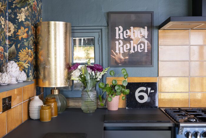 The built-in sink and worktop are in the same grey as the units to highlight the wallpaper and tiles. ‘The Not in Service sign is a reference to me being a terrible cook. I’ve got a lovely oven, which is completely wasted, but looks beautiful and that’s good enough for me.