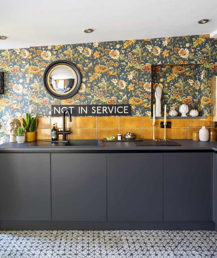 The built-in sink and worktop are in the same grey as the units to highlight the wallpaper and tiles. ‘The Not in Service sign is a reference to me being a terrible cook. I’ve got a lovely oven, which is completely wasted, but looks beautiful and that’s good enough for me.