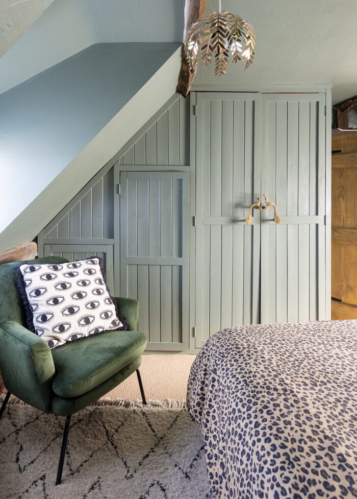 Built in boarded wardrobes have several size options and Kerry has painted them in Farrow & Ball’s Green Smoke eggshell to match the walls. A gold leaf light and a Berber style rug, both from Dunelm, add a personal touch. 