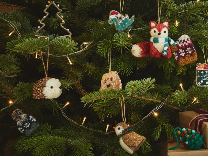 Close up of real Christmas tree with animal decorations and LED lights