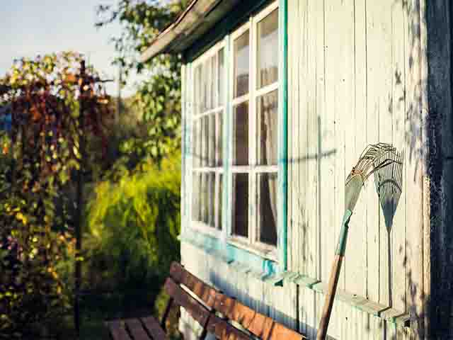 garden shed with rake - top tips for organising your garden shed - garden - goodhomesmagazine.com
