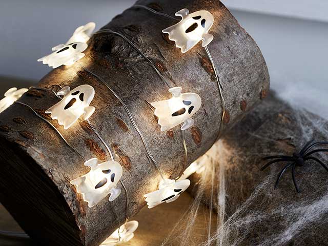 Ghost fairy lights halloween decorations around tree trunk 