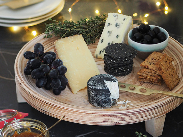 cheese board with black grapes and crackers - kitchen - goodhomesmagazine.com