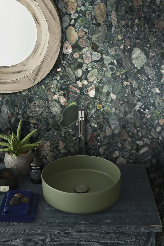 Green marble wall behind bathroom basin