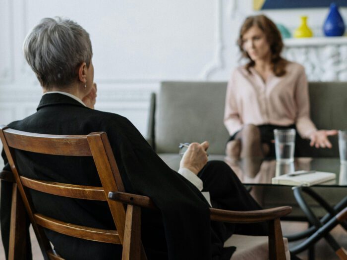 Two people in chairs having a discussion