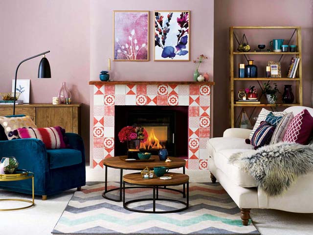 pink and red living room with mix of print and pattern with a fireplace - - ugly interiors