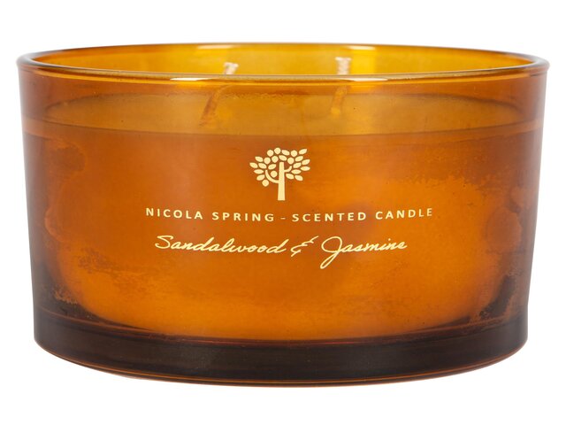 Orange scented candle on white background