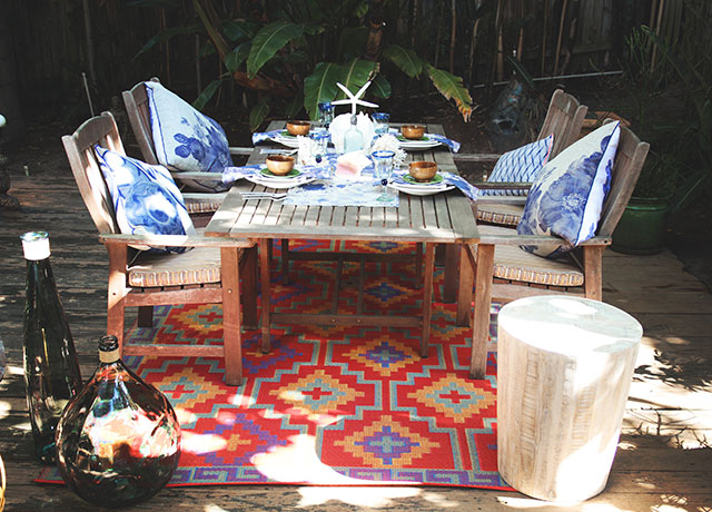 Outdoor dining inspiration: Try a vibrant rug under the table, like this bright outdoor rug from Cuckooland