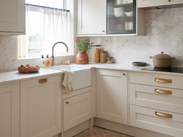 Kitchen with cafe curtain and terracotta tiles from Ca' Pietra