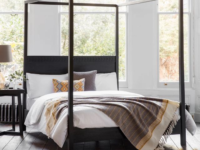 Dark wood four poster bed