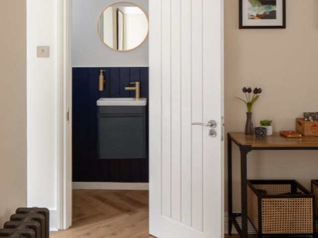 Downstairs toilet with round gold mmirror