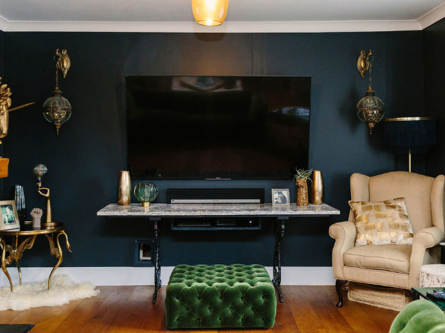 Living room with a dark wall disguising a TV